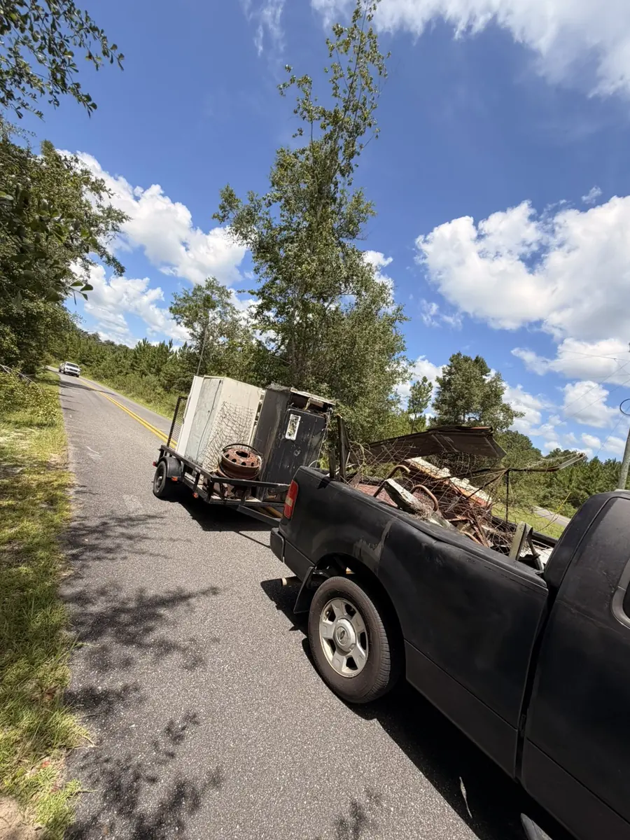 Panhandle Pro truck and trailer loaded with scrap metal, appliances and debris from a property cleanout